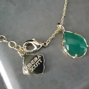 Kendra Scott necklace with green stone pendant.
